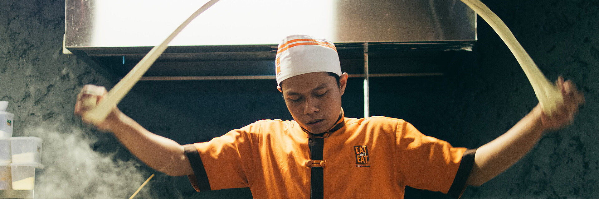 Asian cook with embroidered working shirt