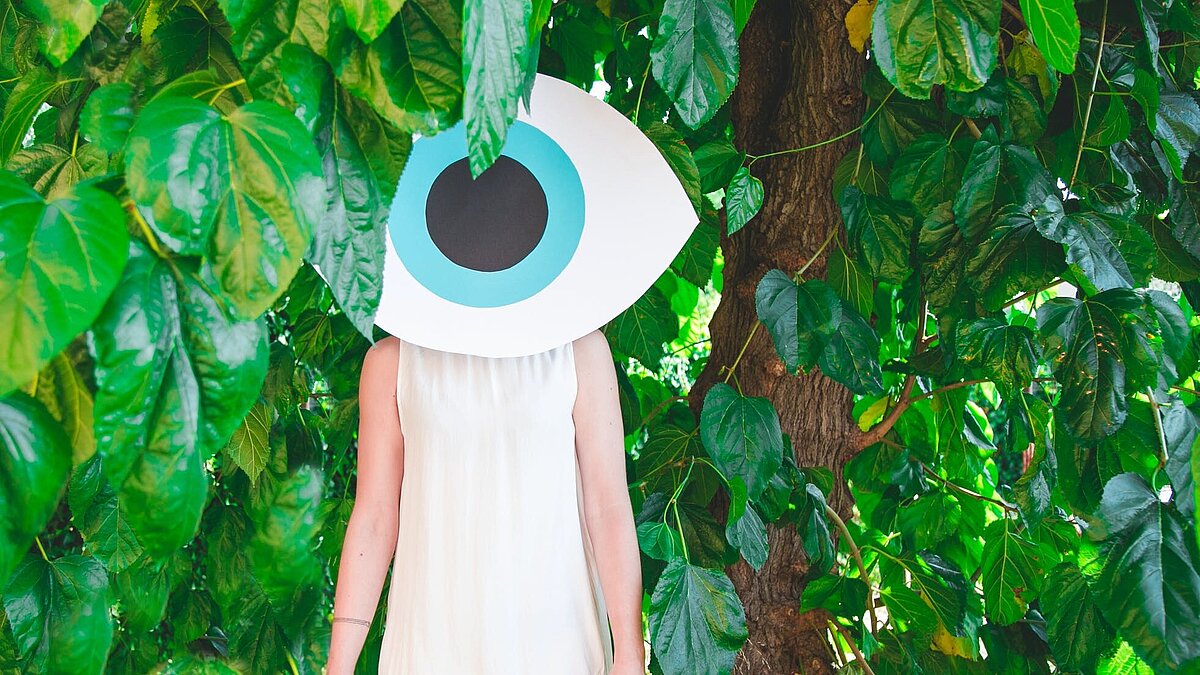 Woman in the forest with a big eye on the environment Woman in the forest with a big eye on the environment