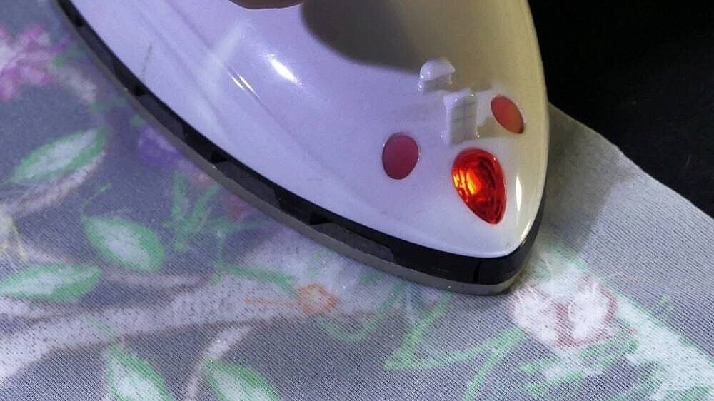 image showing a comfort wear embroidery inlay being ironed onto a fabric