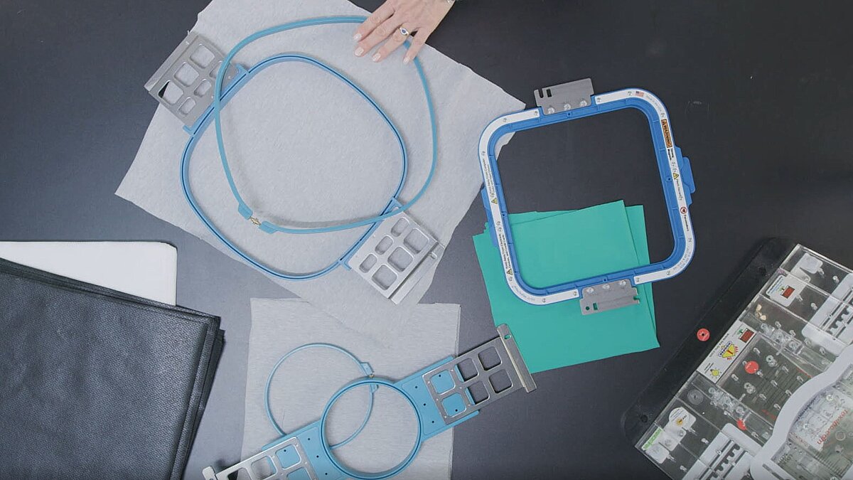 Selection of different standard and magnetic embroidery frames and backings for hooping