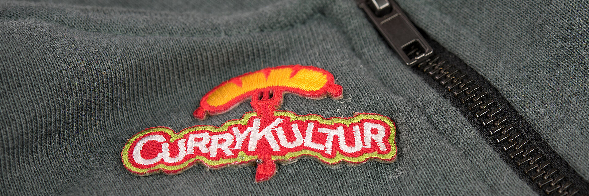 [Translate to Global Französisch:] embroidered fast food logo "Currykultur"