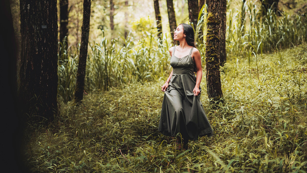 Woman with a green dress admiring the forest Woman with a green dress admiring the forest