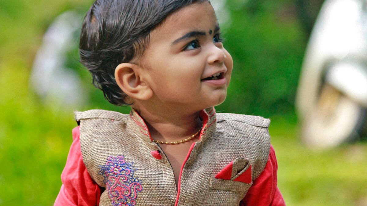 child wearing a traditional embroidered dress
