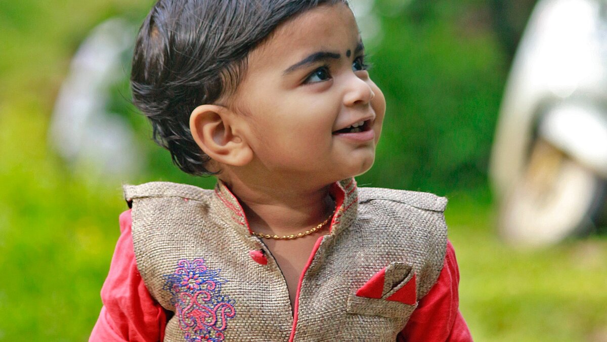 child wearing a traditional embroidered dress