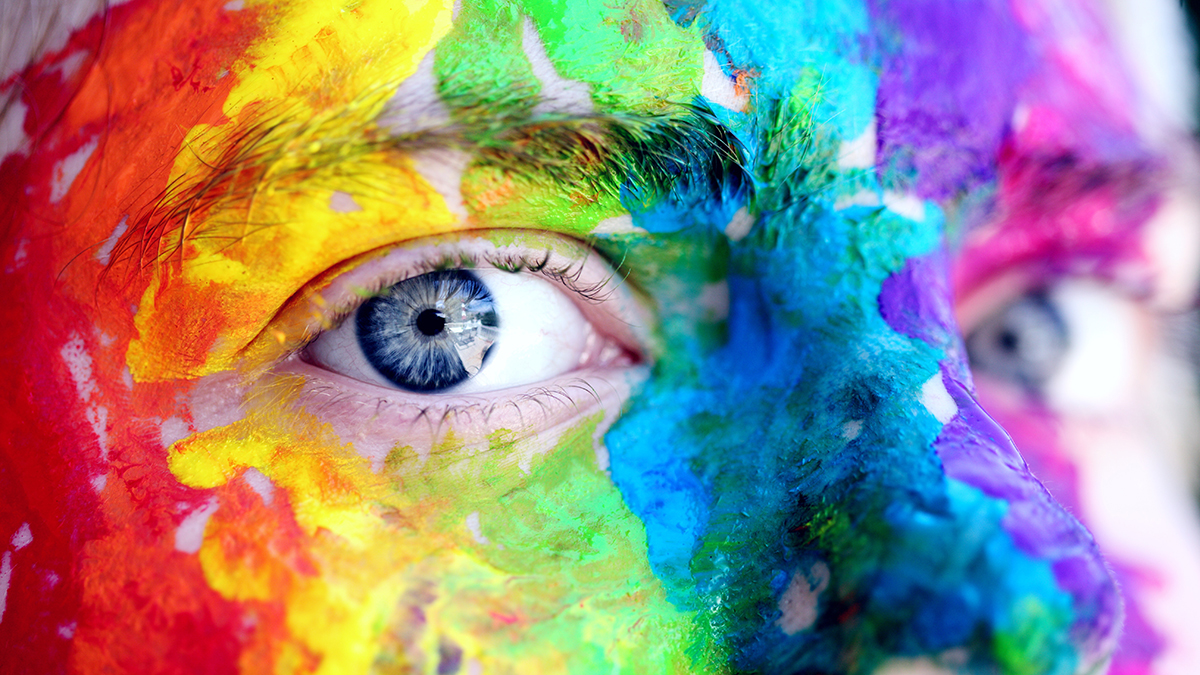 face body painted with many different colours